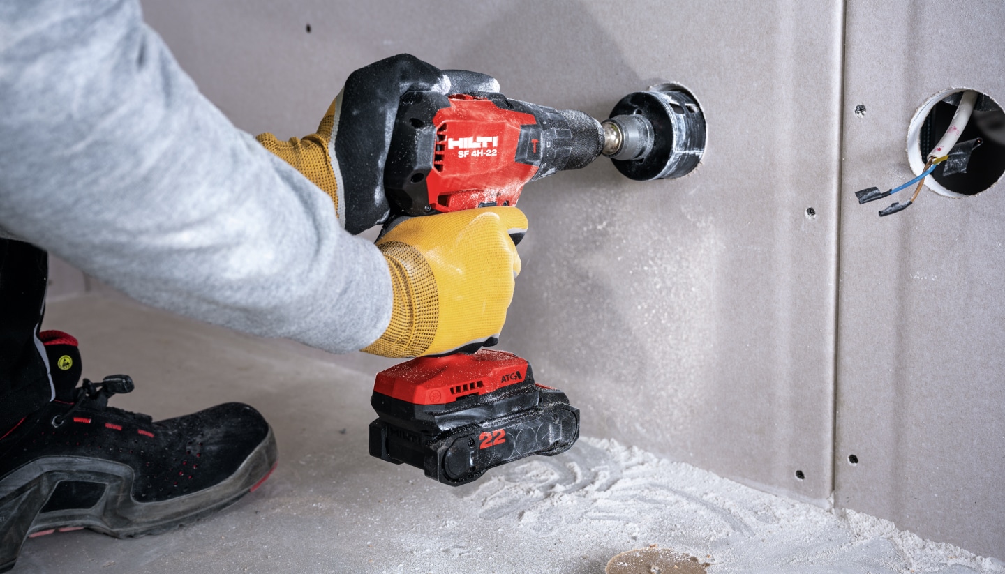 Worker drilling into drywall with SF 4H-22