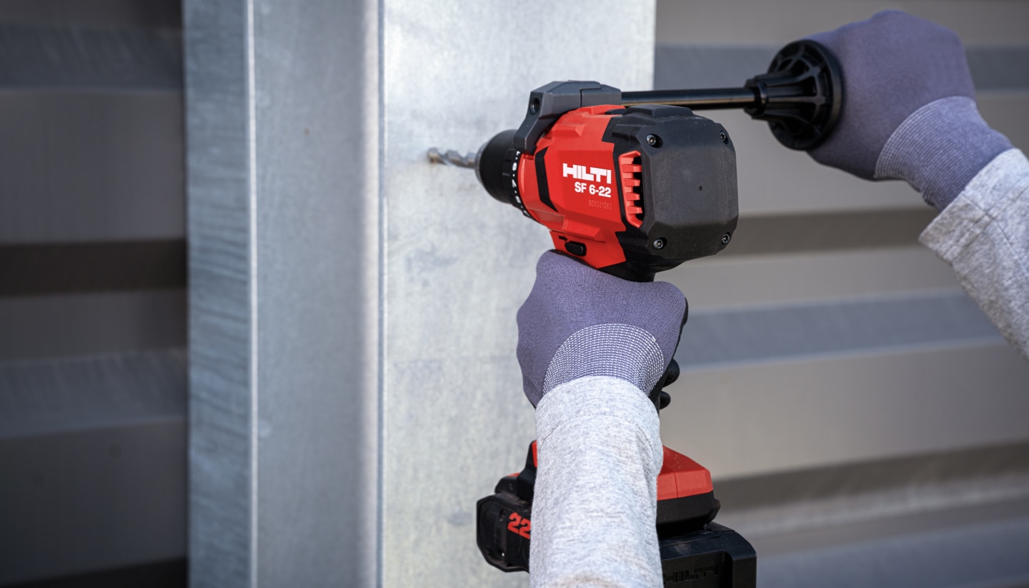 Worker using SF 6H-22 3rd generation Nuron cordless hammer drill driver with B22-110 battery and HSS drill bit to drill into metal