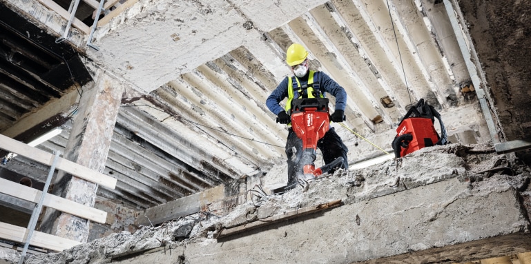 TE 2000-AVR concrete demolition hammer being used with a dust removal system and vacuum cleaner for virtually dust-free chiseling / breaking